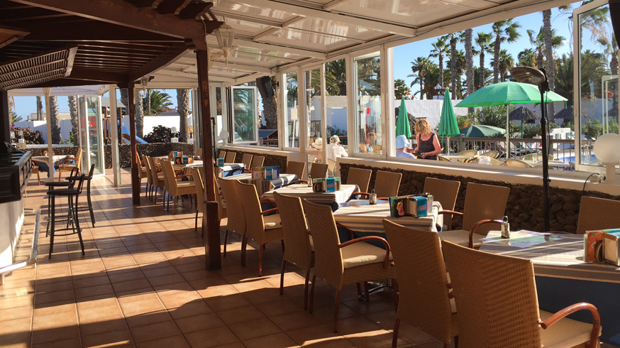 The well-stocked and comfortable bar is right by the swimming pool.